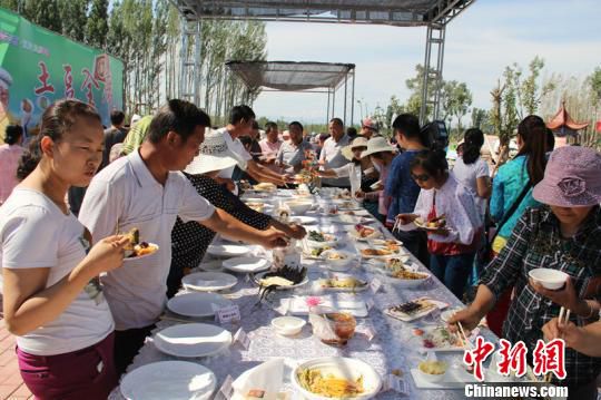 在新疆瑪納斯縣蘭州灣鎮(zhèn)首屆金土豆文化采摘節(jié)上，民眾品嘗“土豆全席宴”?！∑輥喥?攝