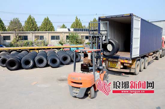 淄博產(chǎn)的輪胎正被裝入集裝箱，通過(guò)“臨新歐”專列發(fā)往新疆。